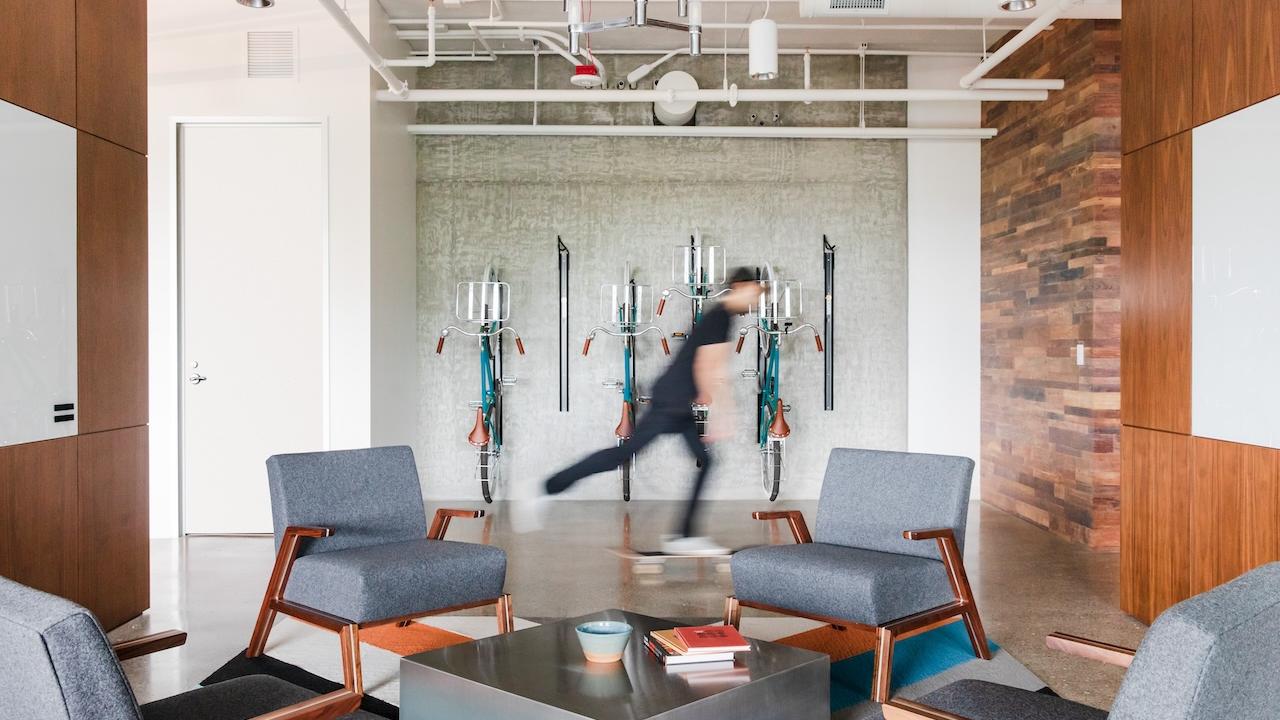 GoDaddy employee shown in corporate office space.
