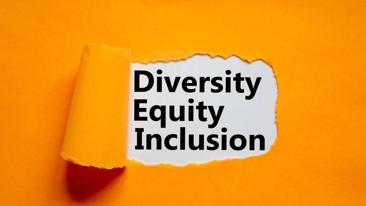 piece of orange paper pealed back in the middle, revealing text that reads "diversity equity inclusion"