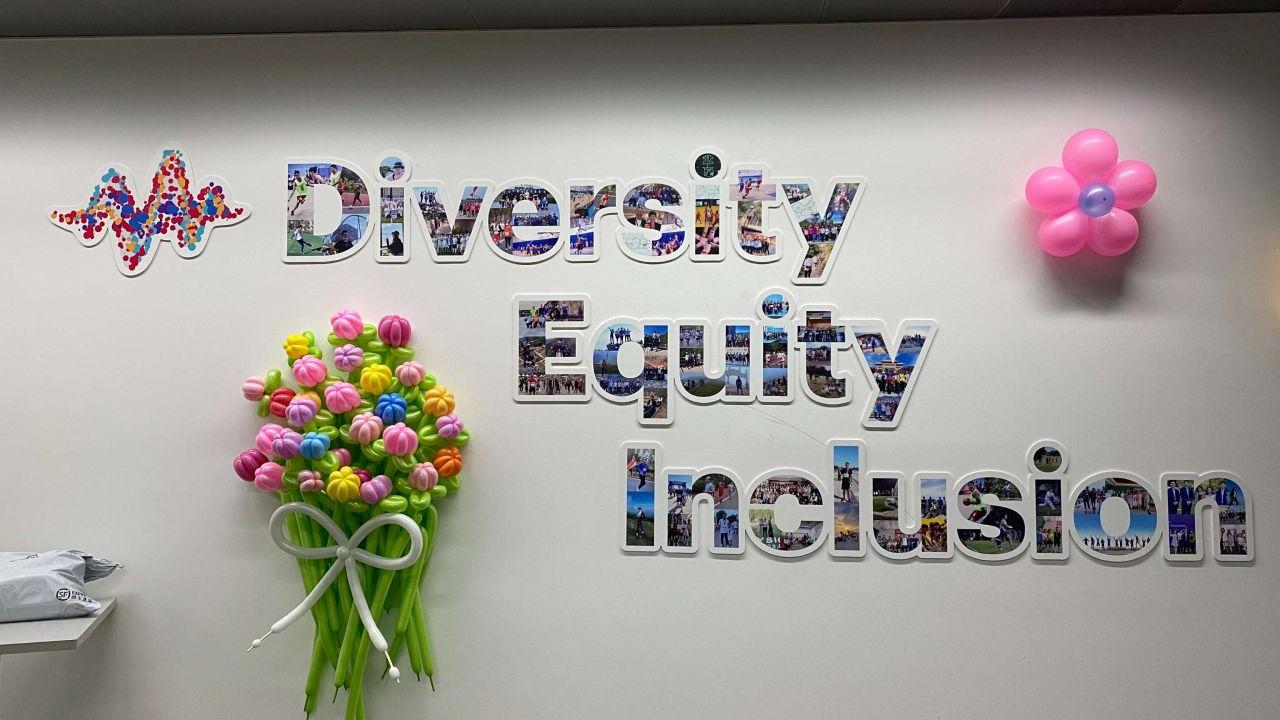 Wall display with the words "Diversity Equity Inclusion" made out of photos