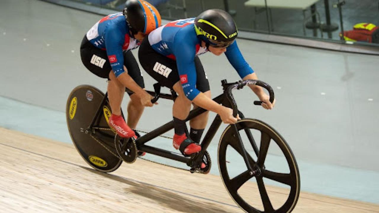MK Wintz, front, pilots a tandem bike ahead of riding partner Hannah Chadwick, who is visually impaired and rides in the back “stroker” position. MK, who does not have a physical impairment, helps guide the bike through the track.