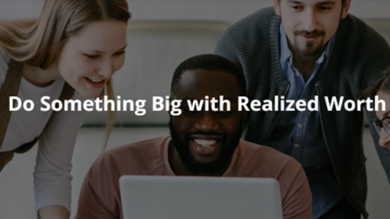 4 people looking at a laptop. Reads: Do something Big with Realized Worth