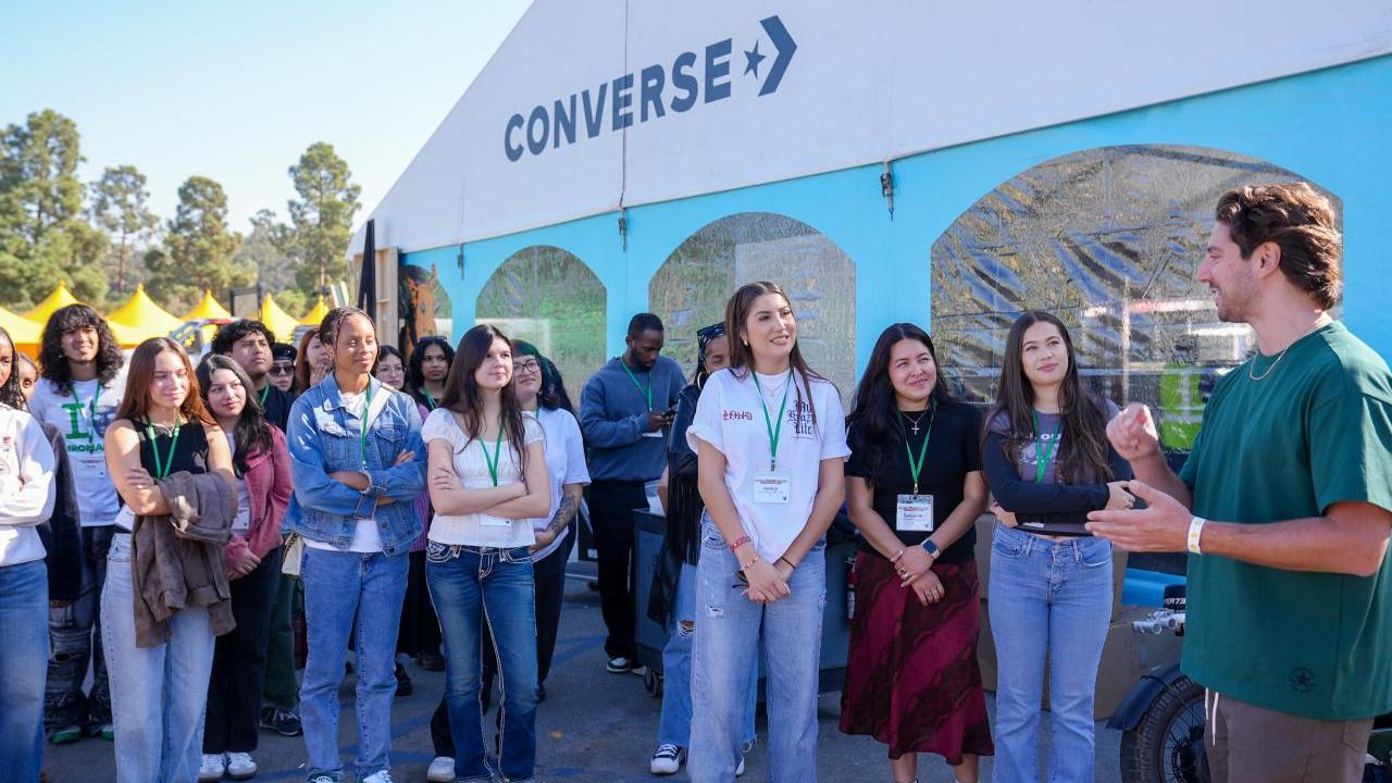 Group of students listening to speaker outside
