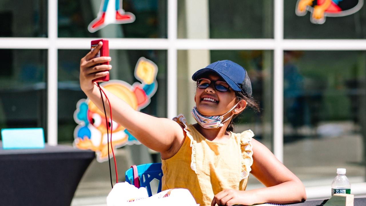 Girl holding up science project