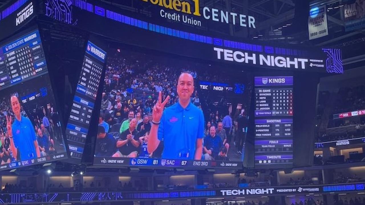 Tom Tran being honored by the Sacramento Kings. Shown on a video monitor at a game.