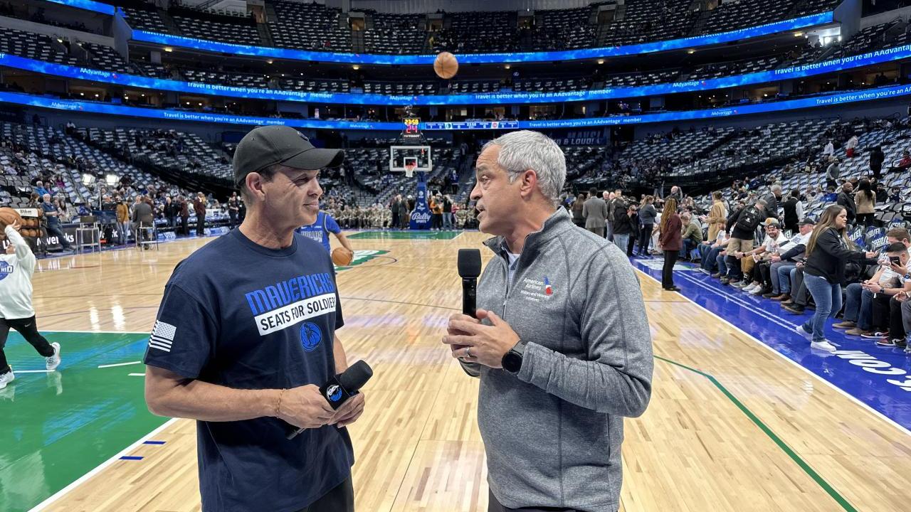 Two men talking on mics on the basketball court