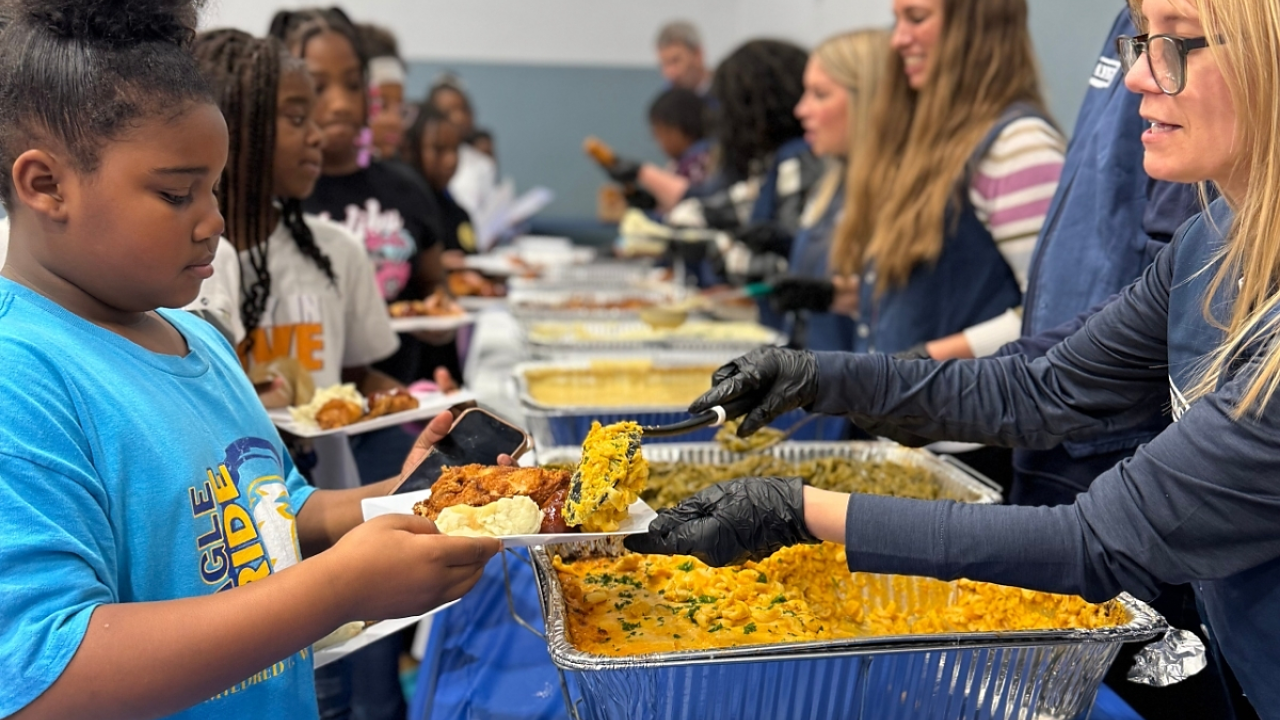 Children picking up plates of food at Day Of Dependability Dinner 
