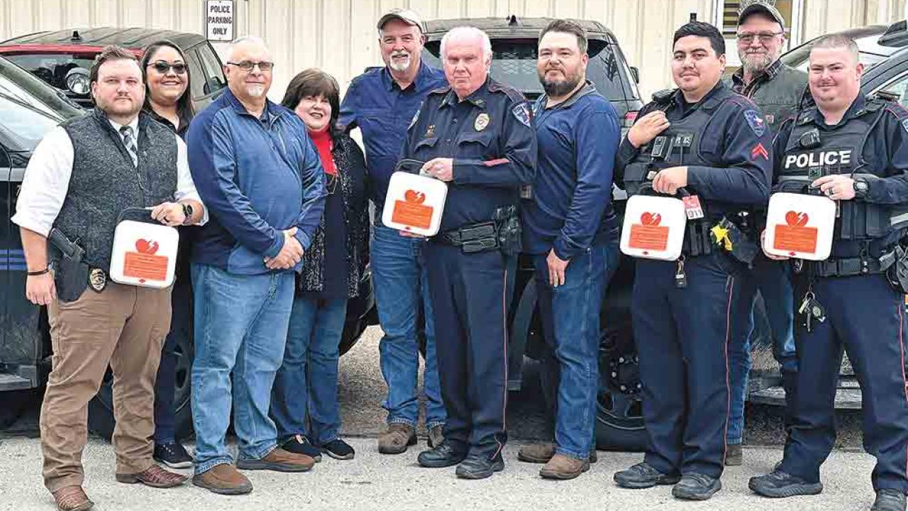 Group of first responders holding defibrillators 