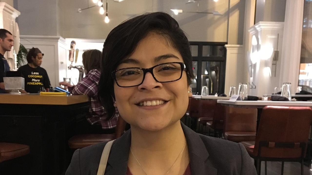 Denisse De la Cruz, sitting at restaurant 