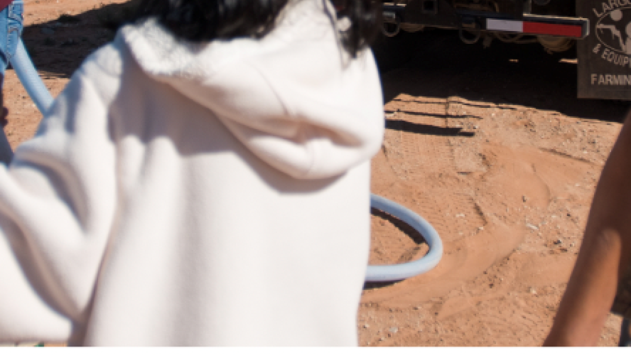 Woman in front of DigDeep water truck