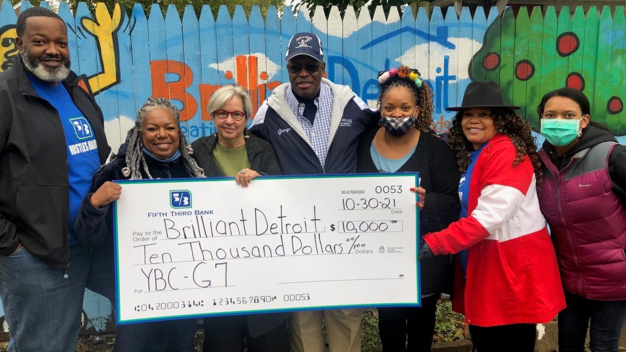 Members of Brilliant Detroit holding $10,000 check from Fifth Third Bank