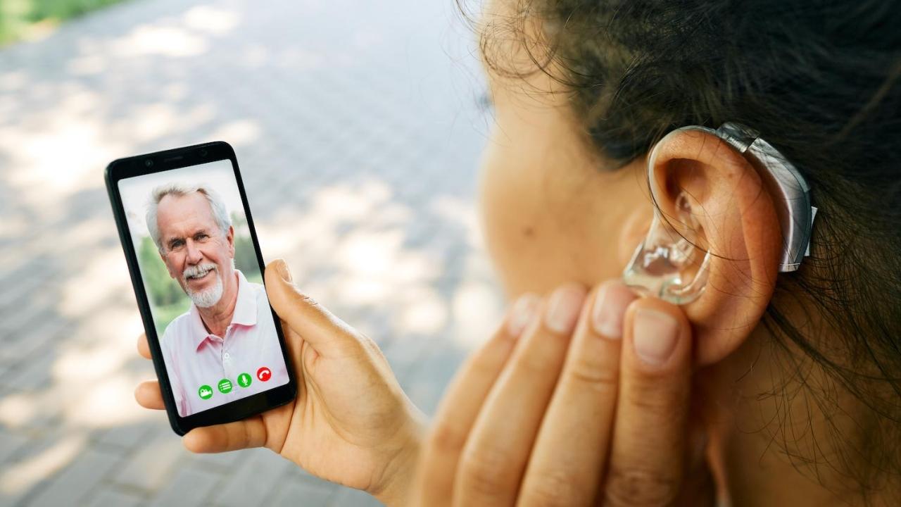 person with hearing aid talking on video call