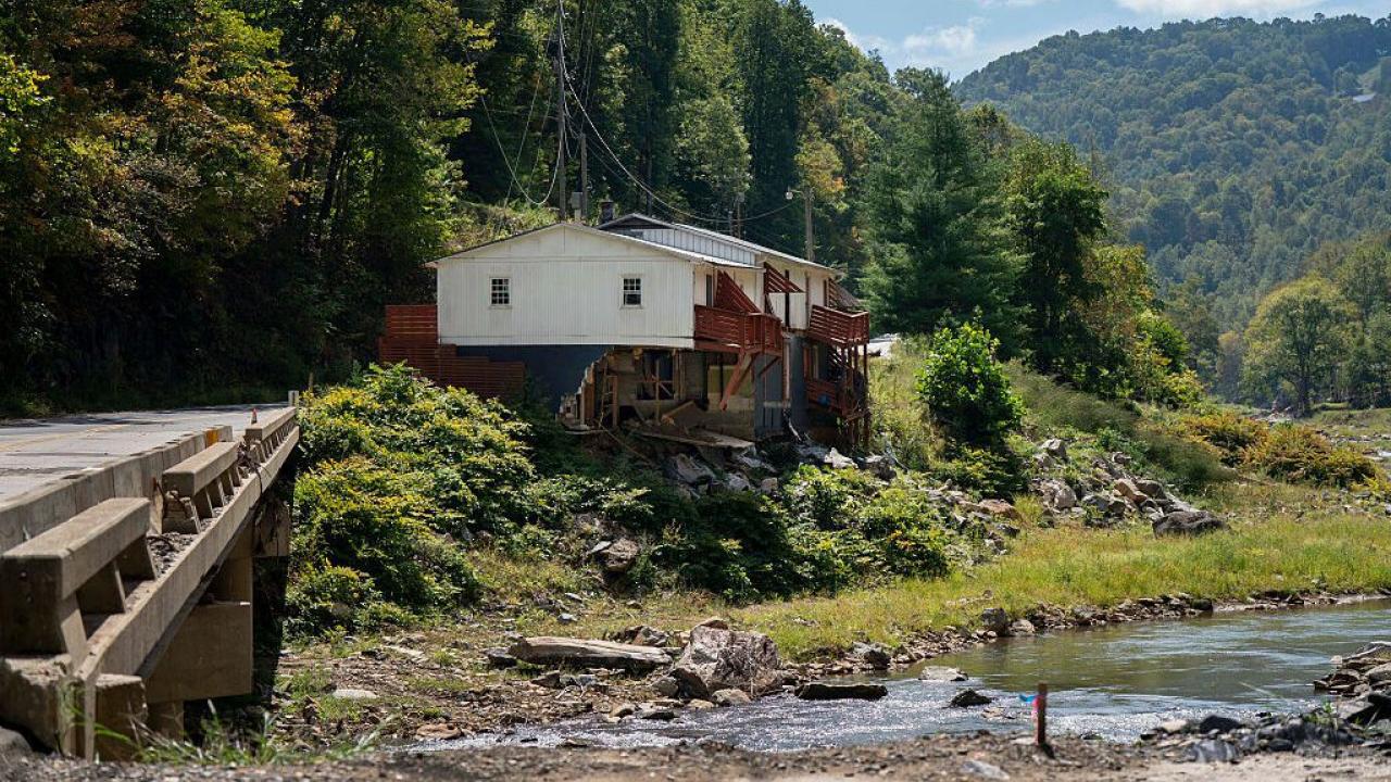 Photo of a house on a riverbank.