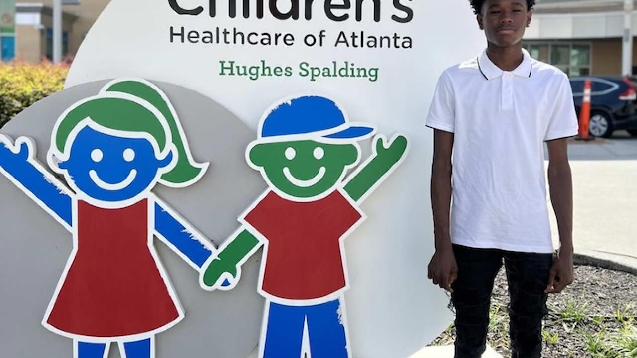 Learning to fly; Kordell shown in front of the Children's Healthcare of Atlanta.