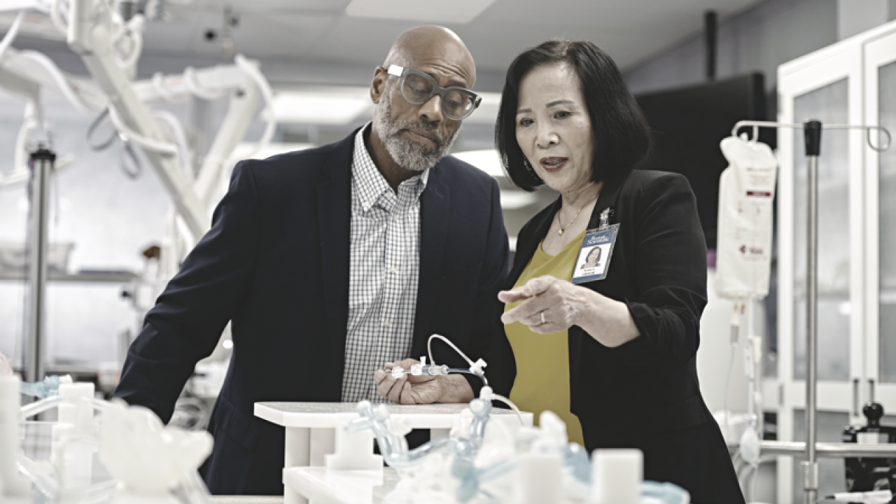 two individuals looking at medical equipment
