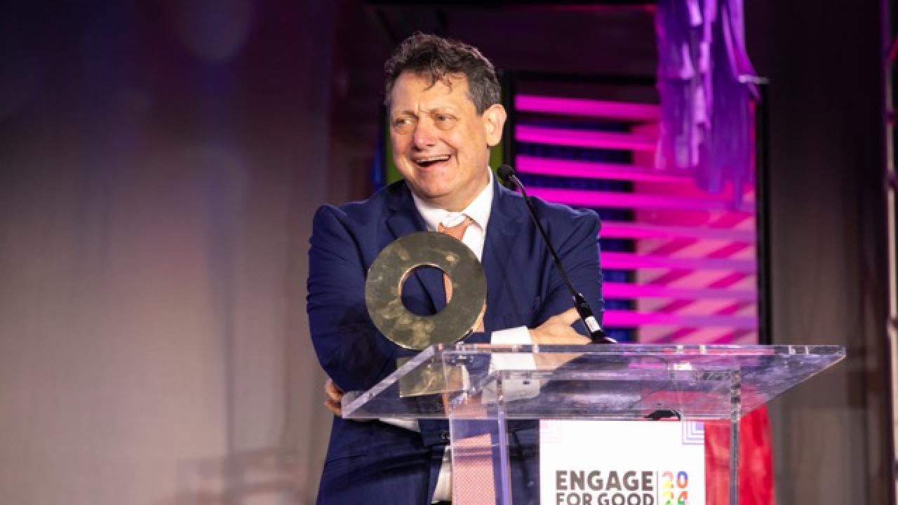 Man accepting award on stage