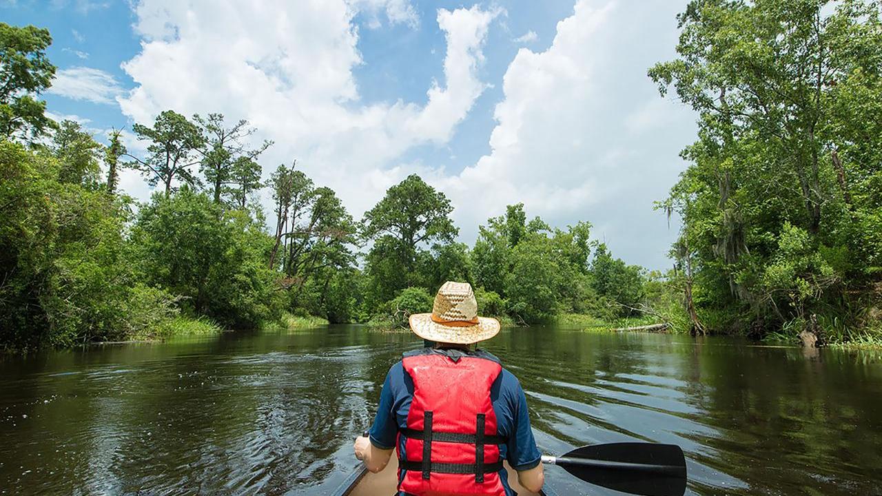 person kayaking down a river