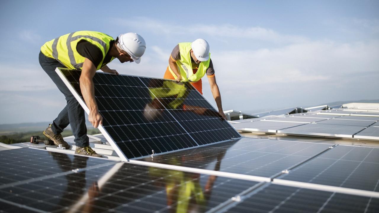 Workers installing solar panels.