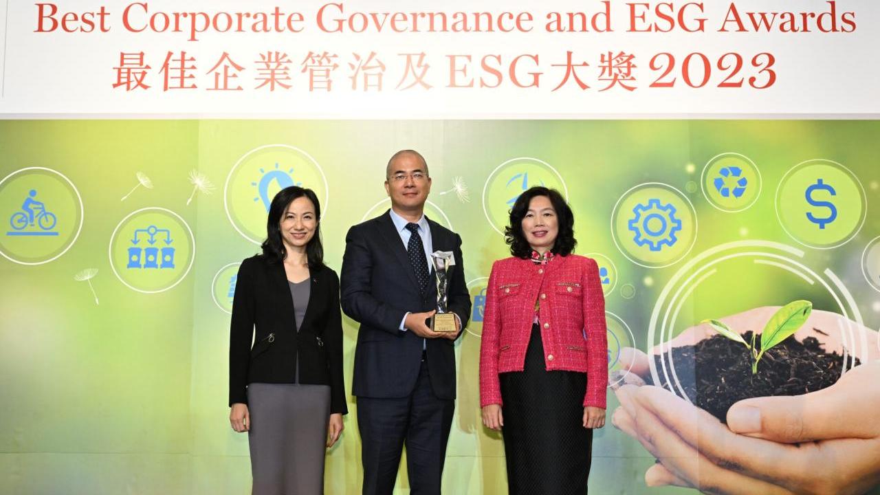 Three people stood together at the annual Best Corporate Governance and ESG Awards