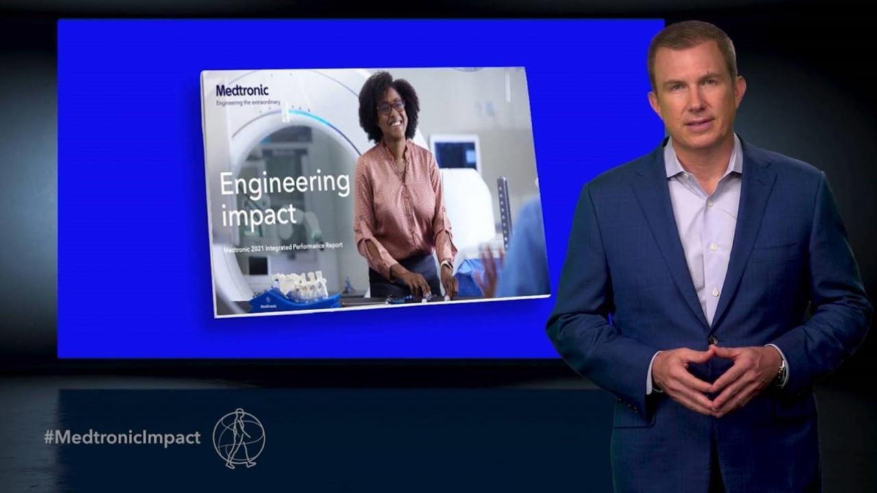 person presenting in front of television screen