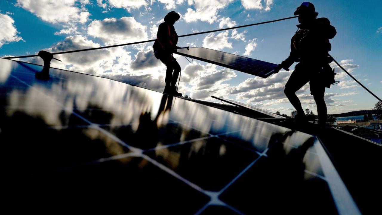People installing solar panels