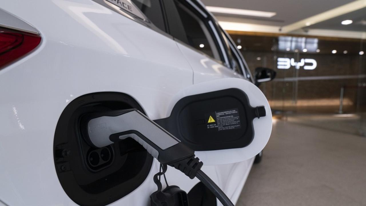 An electric white car being charged 