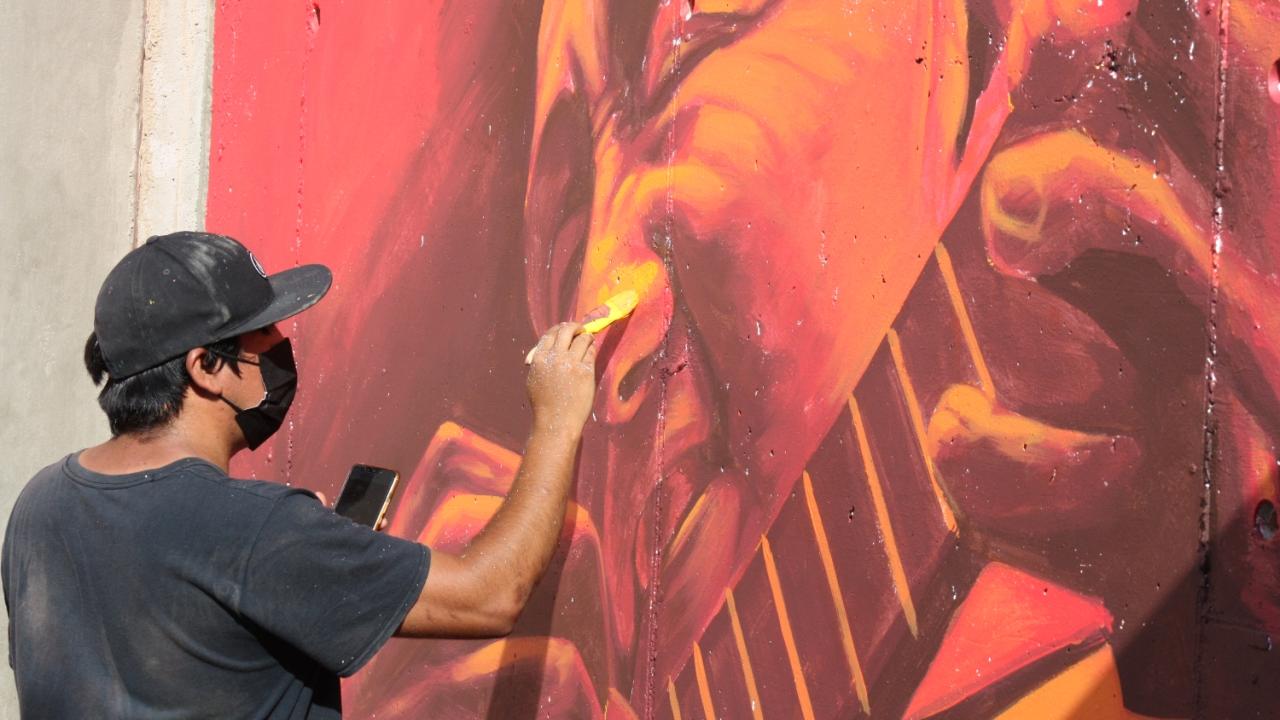 Person painting mural