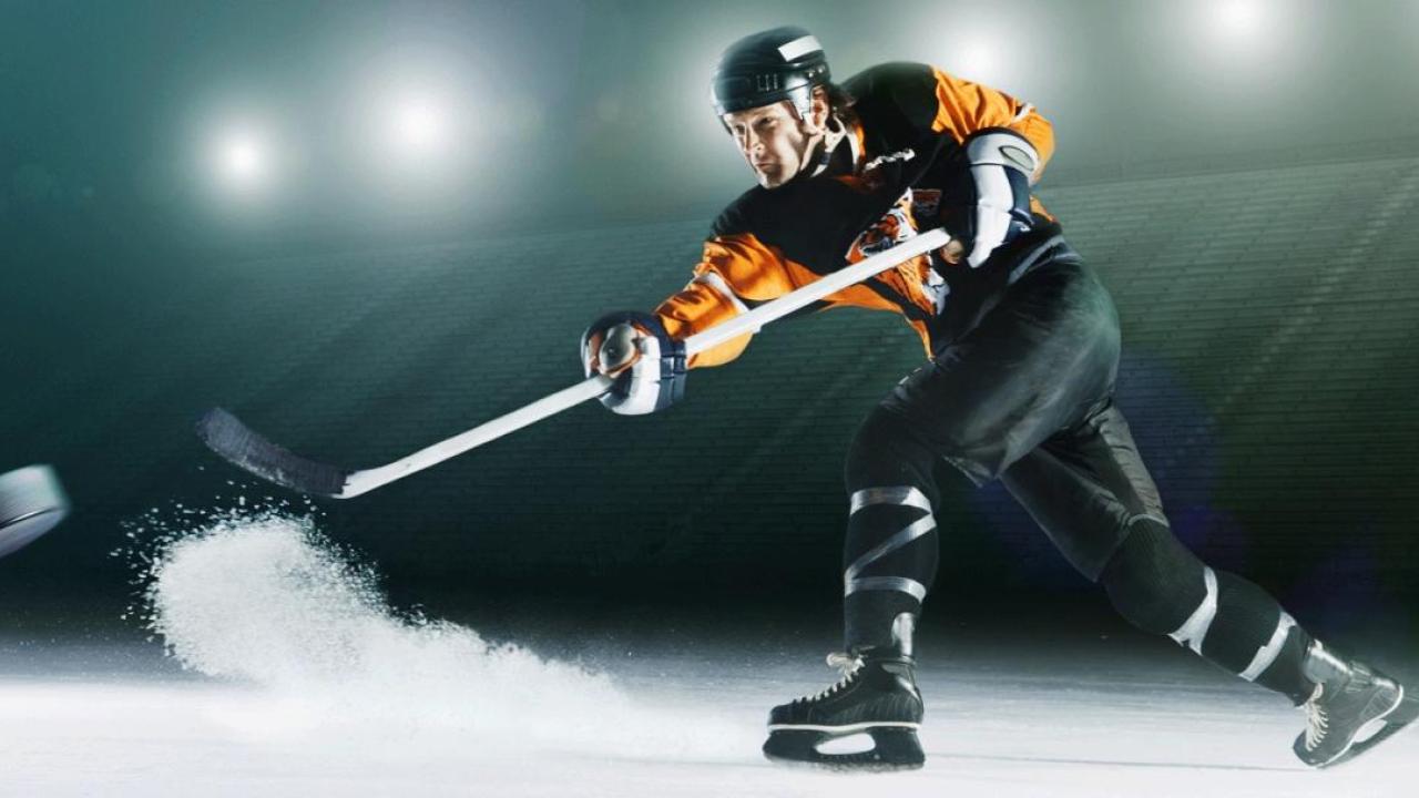 Hockey player hitting the puck