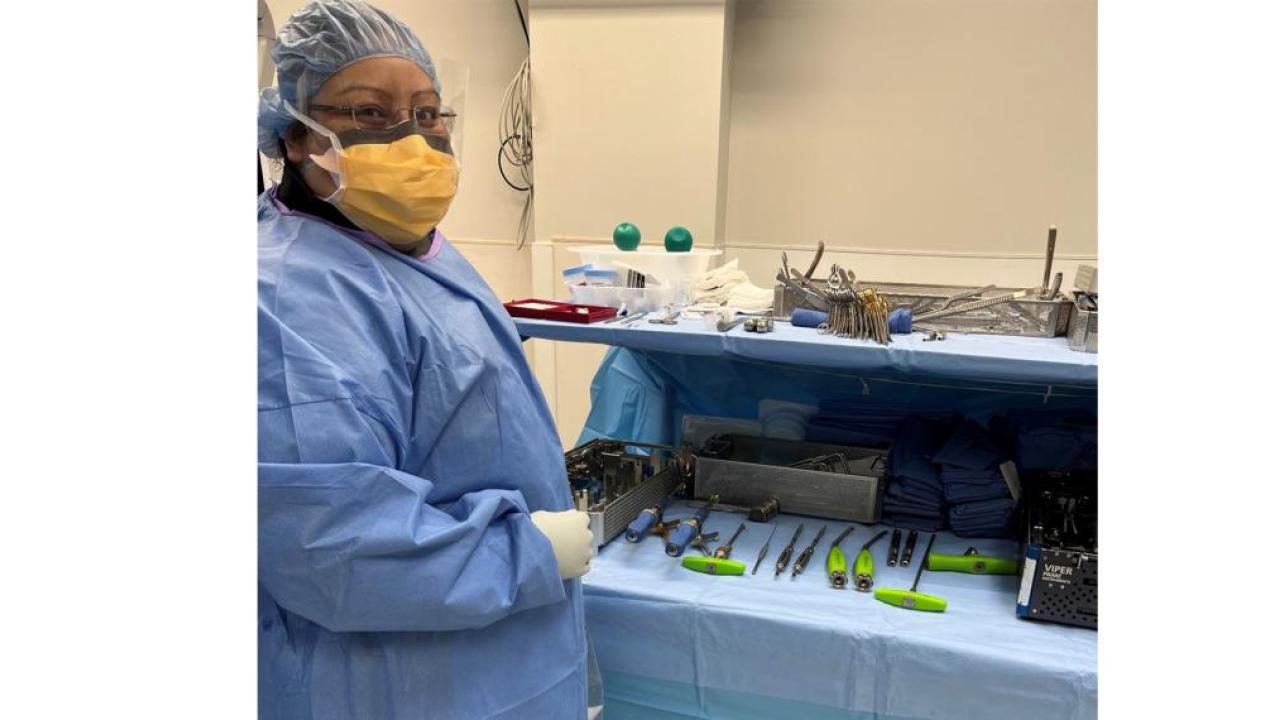Elizabeth Arroyo Gomez stood next to a table of health care technology tools