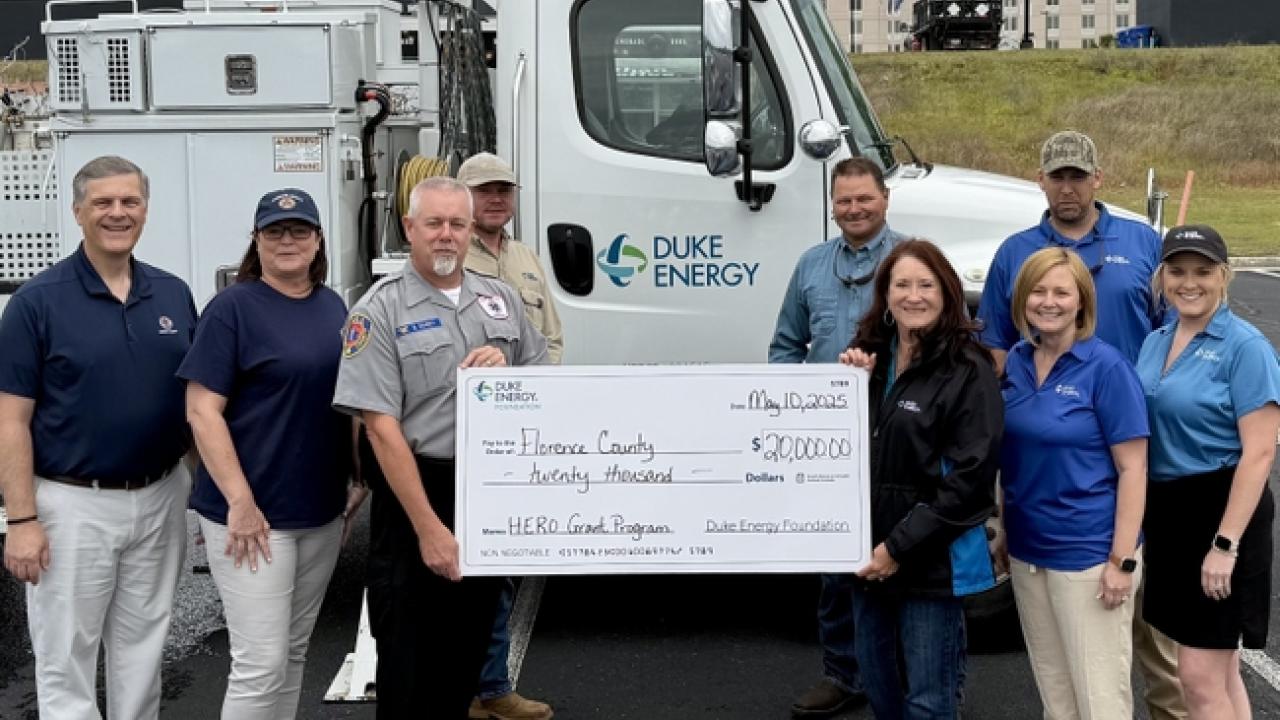 First responders holding check from Duke Energy