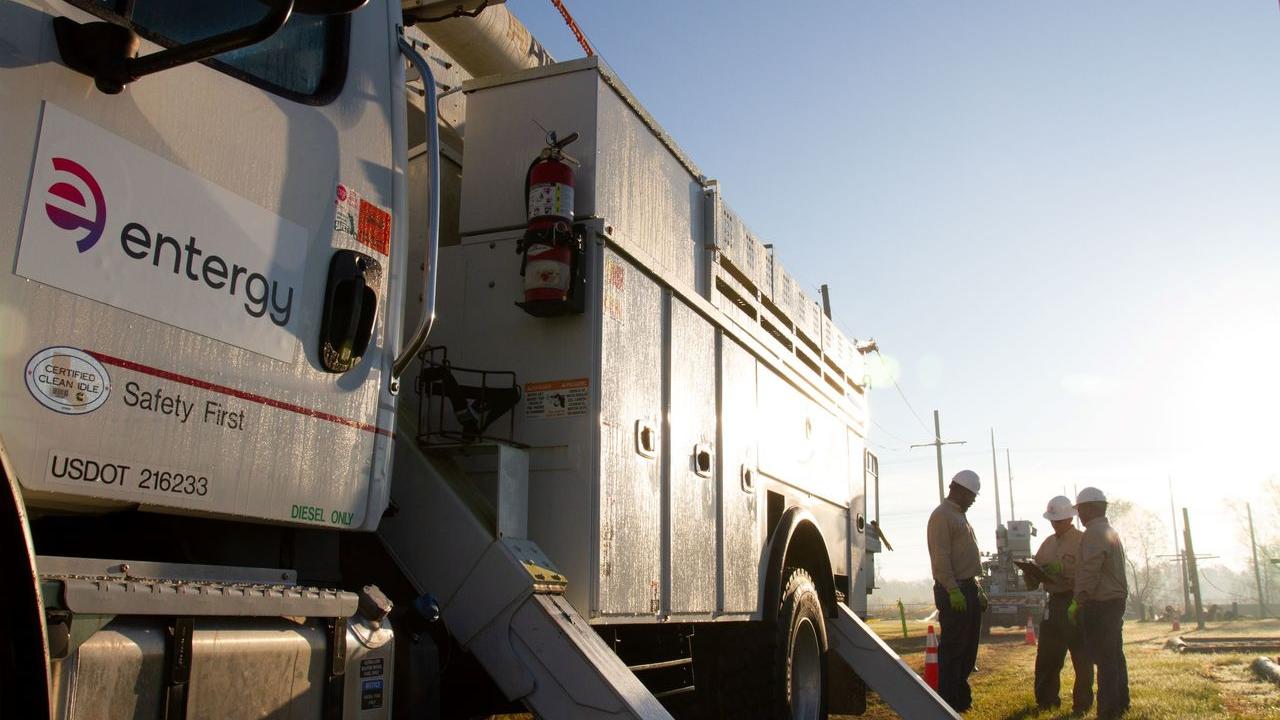Entergy employees standing with truck
