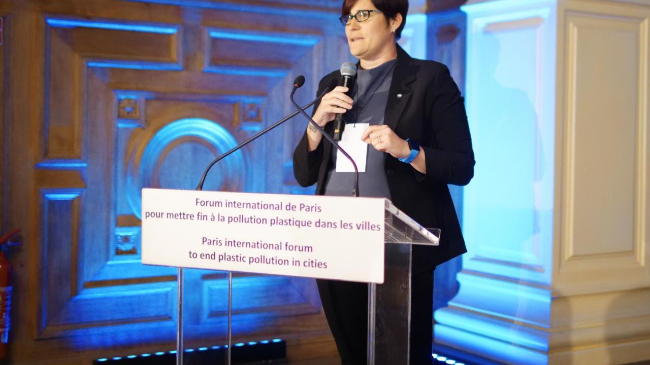 Erin Simon speaks at a lectern on stage