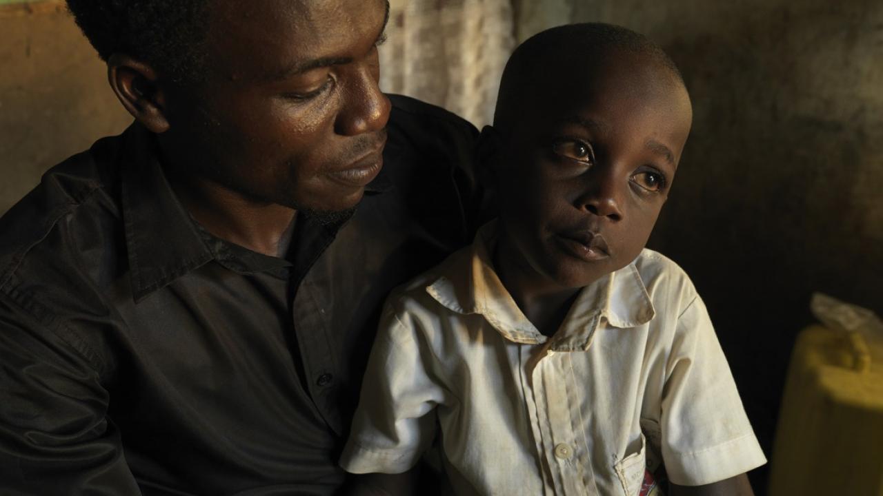 Ernest's son sits in his lap