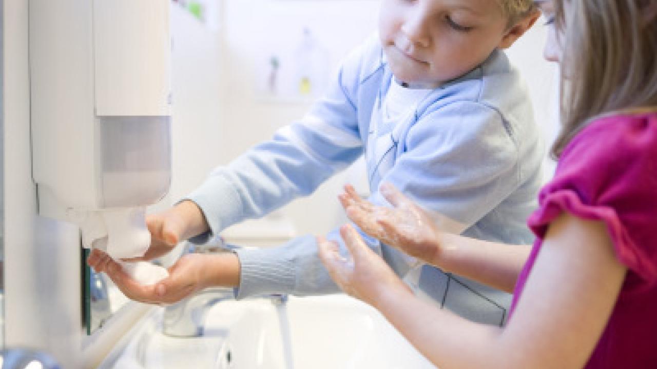 Children washing their hands.