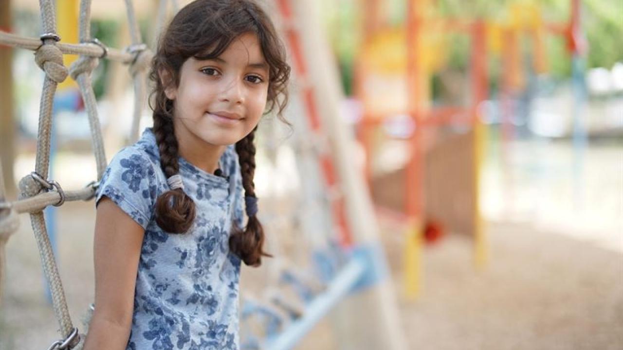 Young girl shown in a playground.