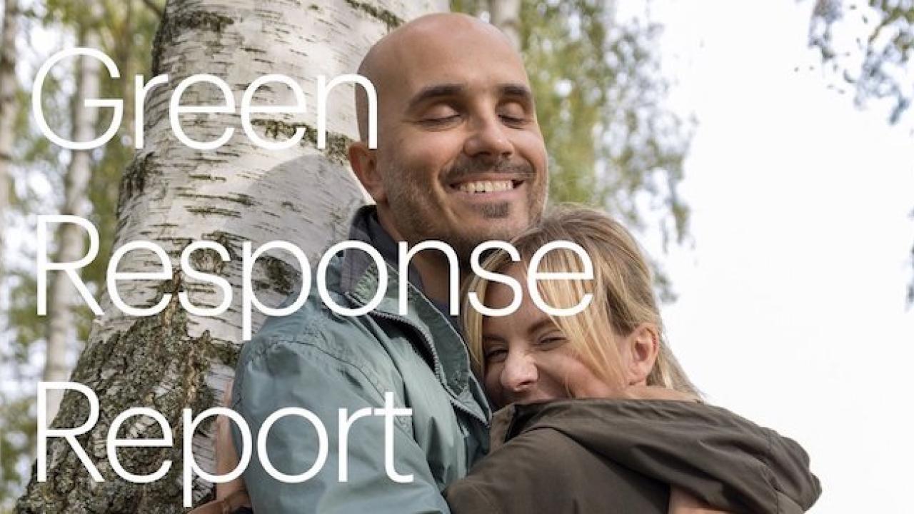 Green Response Report: Father hugging his family while leaning next to a tree.