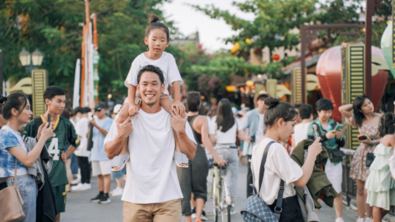 Man with a child on his shoulders.