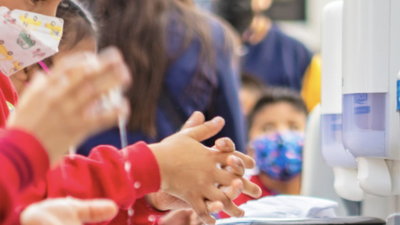 Children washing their hands.