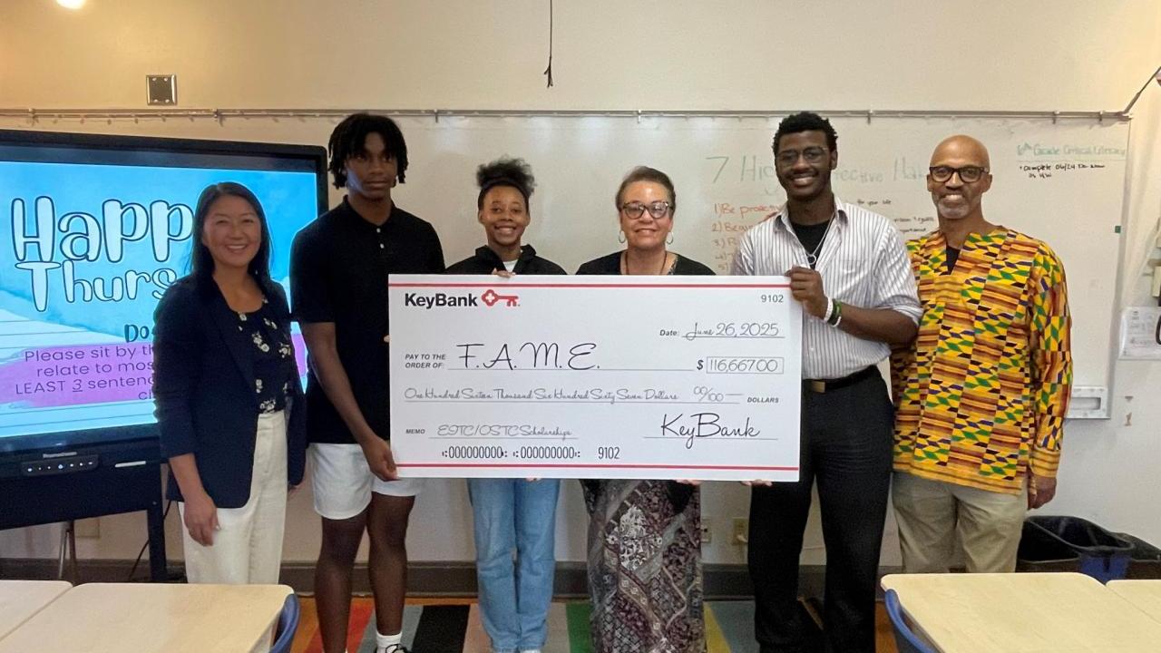 Representatives from FAME and KeyBank shown with a check for $116,670.