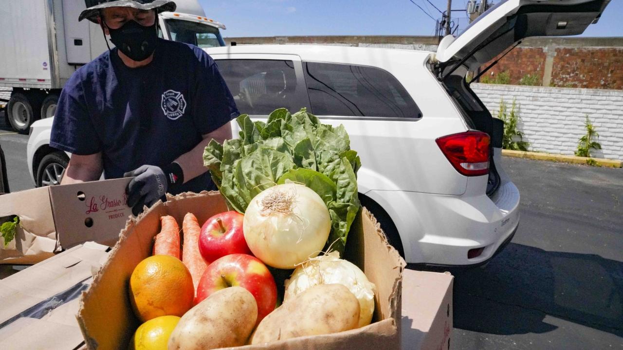 person with a box of fresh produce