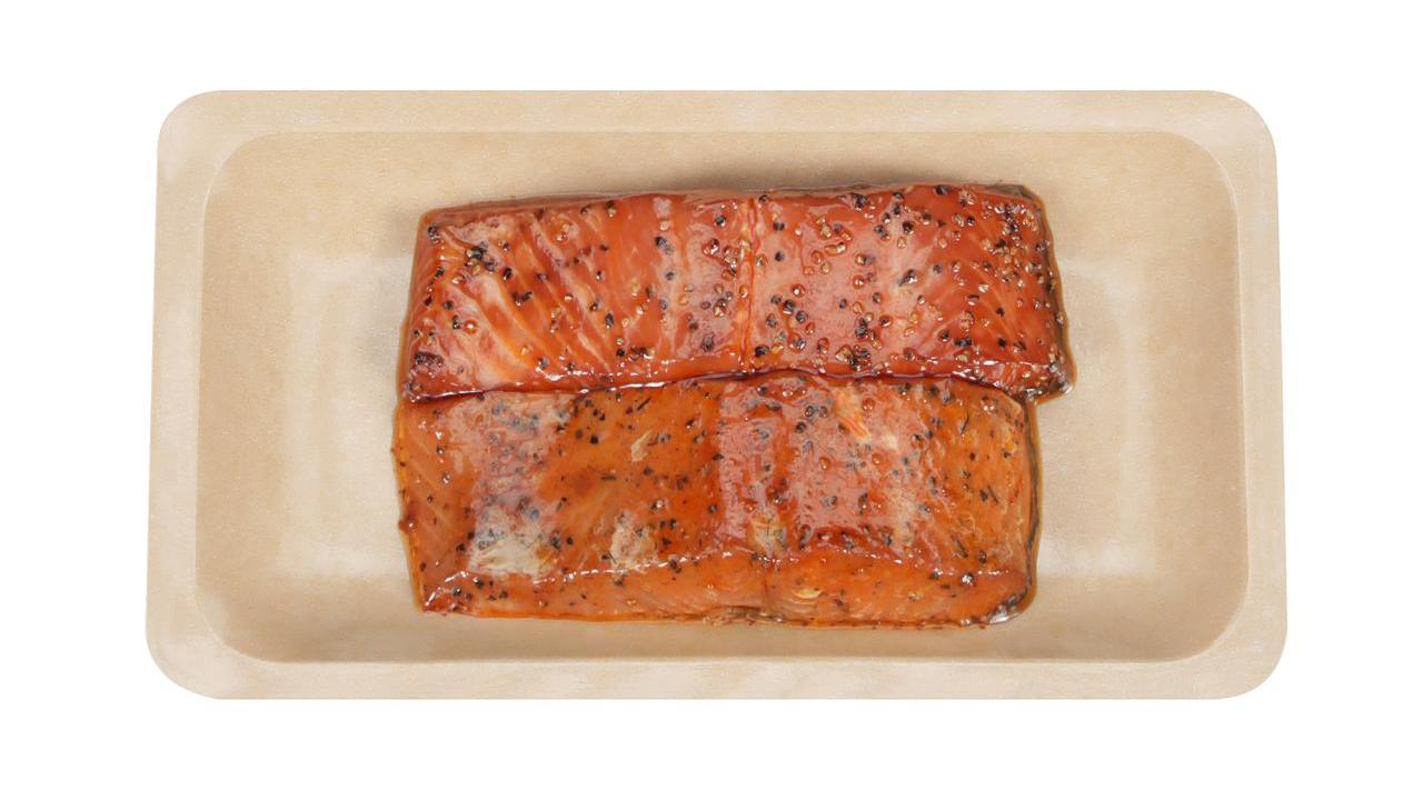 Photo of two smoked salmon fillets sitting in tray packaged for retail sale