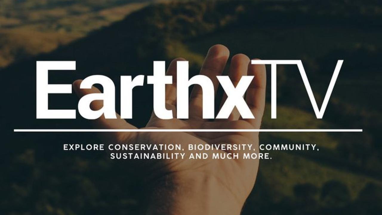 Photo of hand with EarthX TV label. 