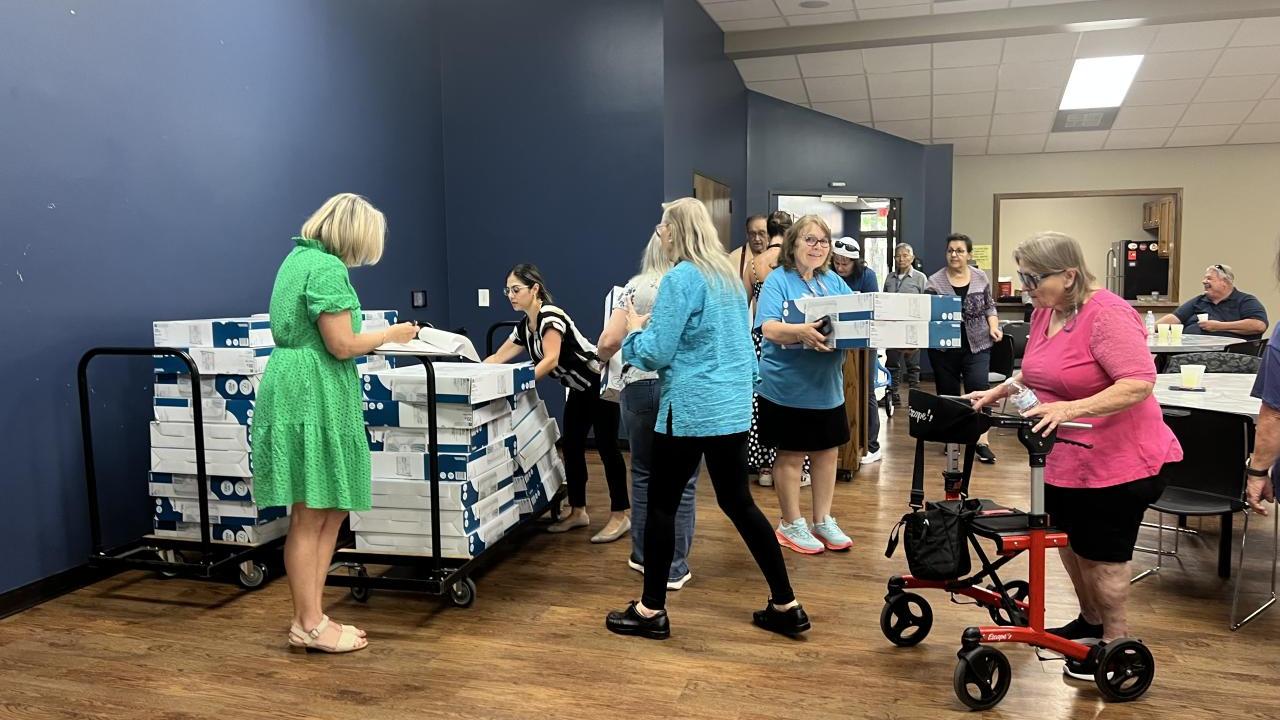 People handing out donated fans to the community
