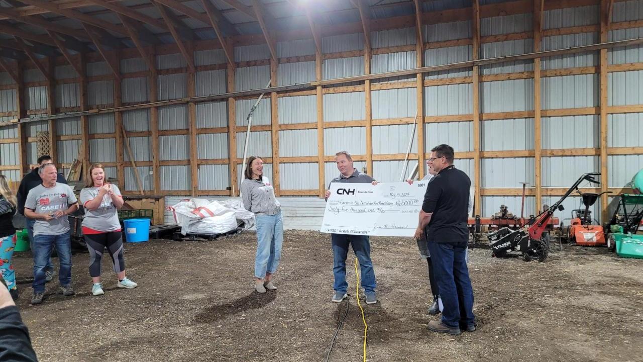 Two people holding a large cheque 