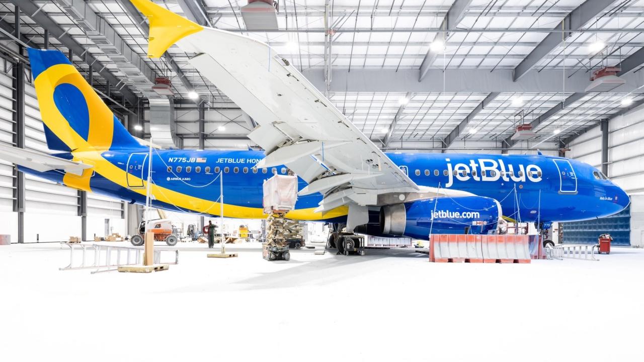 Blue and yellow airplane in hangar