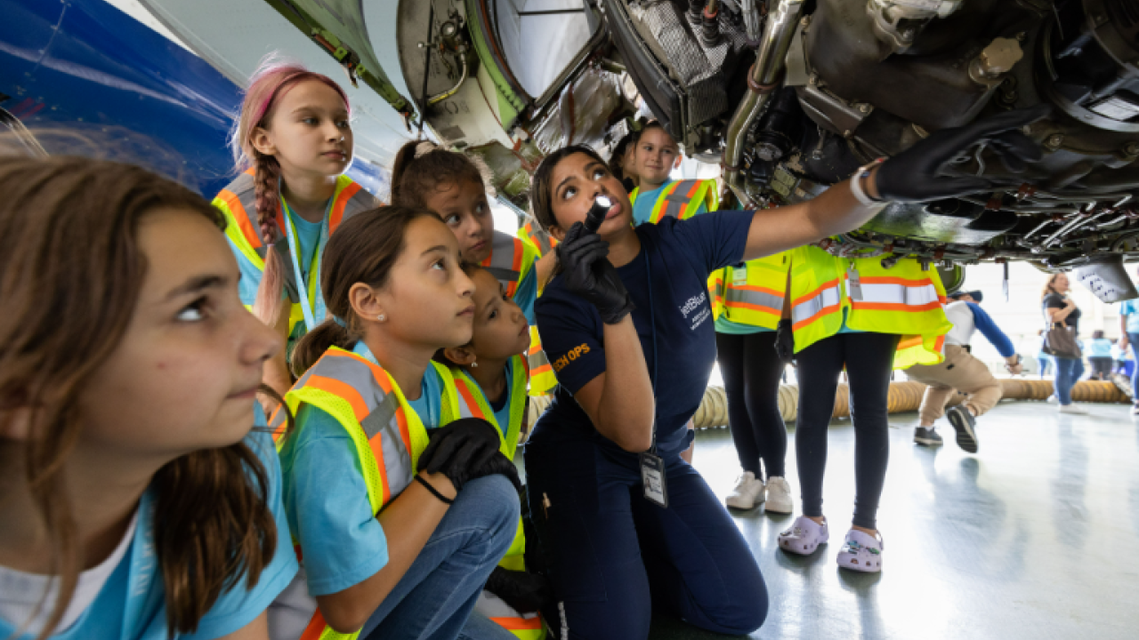 girls looking at an airplane