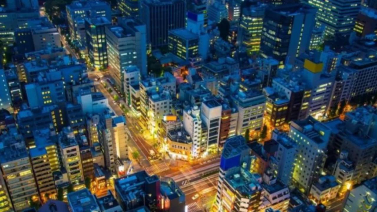a nighttime city scape, long time-elapsed cars on brightly lit streets