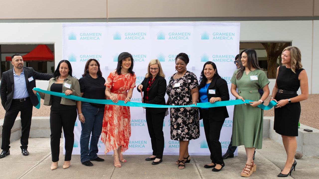 A group of people cutting a ribbon