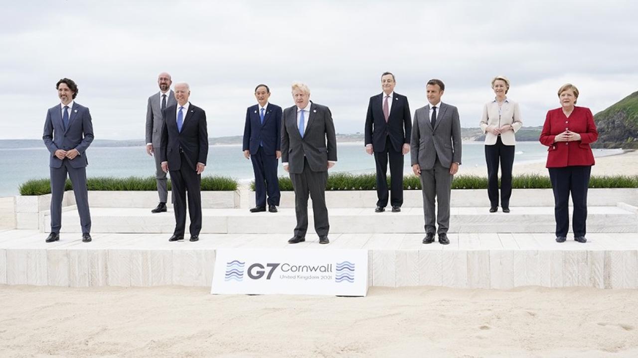 9 Leaders of the G7 pose for a group photo overlooking the beach