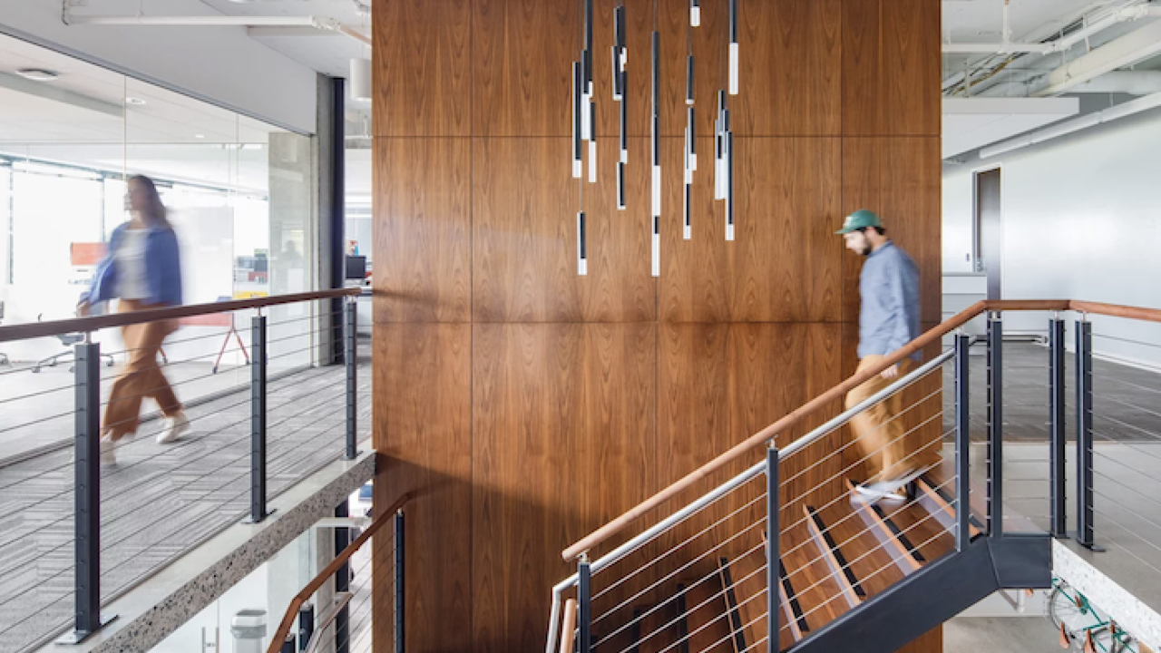 GoDaddy offices, Kirkland. Employee walking down a set of stairs.