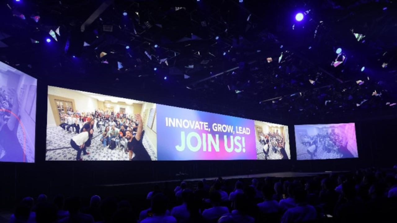 Screen behind the stage for GFC displaying the words, "Join Us!" 